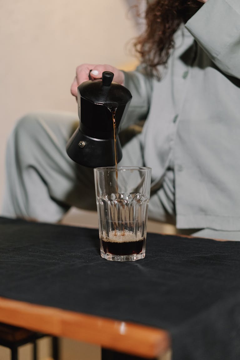 Pouring coffee for stress free morning routine.